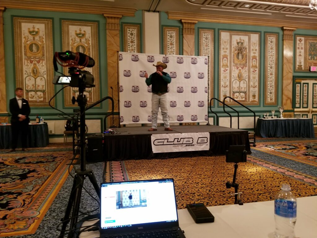 Camera and laptop streaming rig set up at a banquet hall event